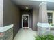 Front door entry with stone accents and a wreath at 3015 Winglewood Cir, Lutz, FL 33558