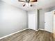 Well-lit bedroom with double door closet and wood-look floors at 9083 Quail Creek Dr, Tampa, FL 33647