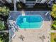 Community pool with surrounding patio and lounge chairs at 4611 W Fig St # 304, Tampa, FL 33609