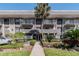 Building exterior showcasing entrance, landscaping, and balconies at 4611 W Fig St # 304, Tampa, FL 33609