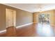 Bright living room with wood floors, sliding glass doors, and access to balcony at 4611 W Fig St # 304, Tampa, FL 33609