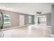 Living room with light gray walls, wood-look floors, and ceiling fan at 4420 W Varn Ave, Tampa, FL 33616