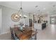 Bright dining room featuring a rustic wooden table and chandelier at 8514 Coastal Palms Gln, Parrish, FL 34219