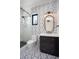 Bathroom with geometric tile, a floating vanity, and a large mirror at 3305 W Beaumont St, Tampa, FL 33611