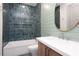 Bathroom with blue tile, a built-in shelf, and a modern vanity at 3305 W Beaumont St, Tampa, FL 33611