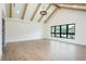 Spacious bedroom with light hardwood floors, high ceilings with exposed beams, and large windows at 3305 W Beaumont St, Tampa, FL 33611