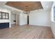 Bright living room with hardwood floors, tray ceiling, and a dramatic chandelier at 3305 W Beaumont St, Tampa, FL 33611