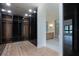 Large walk-in closet with dark glass doors and light wood shelving at 3305 W Beaumont St, Tampa, FL 33611