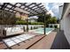 Relaxing pool area with pergola, swing bed, and deck at 3305 W Beaumont St, Tampa, FL 33611