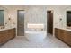 Elegant bathroom with double vanity, free-standing tub, and floral-patterned wall at 3305 W Beaumont St, Tampa, FL 33611