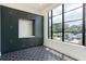 Laundry room with dark green cabinets, geometric floor tile, and a large window at 3305 W Beaumont St, Tampa, FL 33611