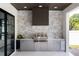 Outdoor kitchen with stainless steel appliances and stone wall at 3305 W Beaumont St, Tampa, FL 33611
