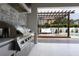 Outdoor kitchen with grill, stone accents, and pergola at 3305 W Beaumont St, Tampa, FL 33611