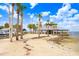 Beach view of large shaded pavilion with palm trees under blue sky at 14620 Coral Dr, Hudson, FL 34667
