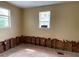 Partially renovated room with natural light, showcasing exposed framing and window views at 14620 Coral Dr, Hudson, FL 34667