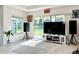 Living room with large TV and sliding glass doors leading to backyard at 32676 Tree Of Life Ave, Wesley Chapel, FL 33543