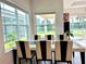 Bright dining area with glass-top table and view to backyard at 32676 Tree Of Life Ave, Wesley Chapel, FL 33543