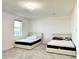 Bright bedroom with two double beds and window at 32676 Tree Of Life Ave, Wesley Chapel, FL 33543
