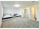 Upstairs bedroom with two twin beds and en-suite bathroom at 32676 Tree Of Life Ave, Wesley Chapel, FL 33543