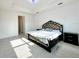 Spacious main bedroom with a king-size bed and access to an ensuite bathroom at 32676 Tree Of Life Ave, Wesley Chapel, FL 33543