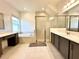 Elegant bathroom with soaking tub, shower, and double vanity at 32676 Tree Of Life Ave, Wesley Chapel, FL 33543