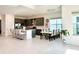 Modern kitchen with gray cabinets, a large island, and tile flooring at 32676 Tree Of Life Ave, Wesley Chapel, FL 33543