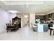 Open floor plan showing kitchen, dining area, and entryway with tile flooring at 32676 Tree Of Life Ave, Wesley Chapel, FL 33543