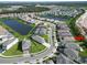 Aerial view of house in a residential neighborhood near a lake at 32676 Tree Of Life Ave, Wesley Chapel, FL 33543