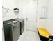 Laundry room with washer, dryer, and shelving at 32676 Tree Of Life Ave, Wesley Chapel, FL 33543