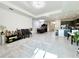 Open floor plan showcasing the living, dining, and kitchen areas with tile flooring at 32676 Tree Of Life Ave, Wesley Chapel, FL 33543