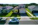 Two-story house with light brown exterior and two-car garage at 32676 Tree Of Life Ave, Wesley Chapel, FL 33543