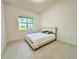 Well-lit bedroom with a queen bed and window at 32676 Tree Of Life Ave, Wesley Chapel, FL 33543