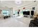 Living room with large TV, sliding glass doors, and tile flooring at 32676 Tree Of Life Ave, Wesley Chapel, FL 33543