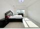 Spacious main bedroom with large windows and an ensuite bathroom at 32676 Tree Of Life Ave, Wesley Chapel, FL 33543