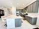 Modern kitchen with gray cabinets and large island at 32676 Tree Of Life Ave, Wesley Chapel, FL 33543