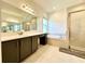 Main bathroom with double sink vanity, soaking tub, and shower at 32676 Tree Of Life Ave, Wesley Chapel, FL 33543