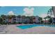 Community pool with lounge chairs and patio at 18001 Richmond Place Dr # 1122, Tampa, FL 33647