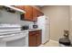 Bright kitchen with white appliances and wood cabinets at 18001 Richmond Place Dr # 1122, Tampa, FL 33647