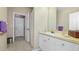 Bathroom with white vanity, shower/tub combo and a mirror at 18001 Richmond Place Dr # 1122, Tampa, FL 33647