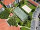 Aerial view of tennis court, sand volleyball court, playground, and parking lot at 18001 Richmond Place Dr # 1122, Tampa, FL 33647
