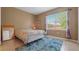Spacious bedroom with a large window and blue rug at 18001 Richmond Place Dr # 1122, Tampa, FL 33647