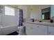 Bathroom with a tub, toilet, vanity, and shower at 18001 Richmond Place Dr # 1122, Tampa, FL 33647