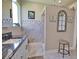 Bright bathroom with a tiled shower and granite countertop at 887 Clear Lake Dr, Englewood, FL 34223