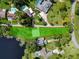 Aerial view showing a lakefront property with a large lot and surrounding homes at 20605 Preston Ln, Lutz, FL 33558