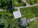 Aerial view of a home and detached building with surrounding landscape at 20605 Preston Ln, Lutz, FL 33558