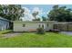 Large grassy backyard with detached structure and partial fence at 20605 Preston Ln, Lutz, FL 33558