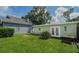 Large backyard with grassy area, shed, and detached building at 20605 Preston Ln, Lutz, FL 33558