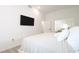 Bright bedroom with a king-size bed and mounted TV at 20605 Preston Ln, Lutz, FL 33558