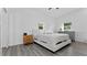 Spacious bedroom with a king-size bed and gray dresser at 20605 Preston Ln, Lutz, FL 33558