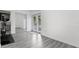 Bright bonus room features wood-look floors, mirrored closet, and French doors leading outside at 20605 Preston Ln, Lutz, FL 33558